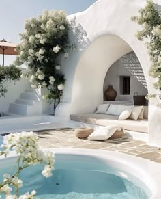 an outdoor jacuzzi with white flowers on it and stairs leading up to the pool