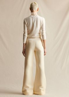 Our classic wide leg trousers made from Italian silk wool. Features an elongating pintuck at the front and a cuff at the ankle. Styled with the Embroidered Top In Pearl Lattice Style Number: AL513SW Made in New York City Size & FitModel's Height: 5'10"Model is wearing size 2 Measurements based on a size 4: Front rise (excluding waistband) 9.625" Back rise (excluding waistband) 14.5" Inseam 36.25" Composition & CareComposition: 77% Wool, 23% Silk Washing Instructions: Dry Clean Only Silk Outfit, Silk Pants, Pantalon Large, Silk Wool, Pin Tucks, Embroidered Top, Crewneck Sweater, Wide Leg Trousers, Crew Neck Sweater