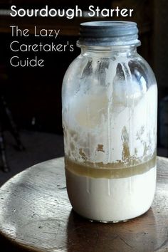 a jar filled with liquid sitting on top of a wooden table