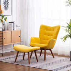 a yellow chair and footstool in front of a window