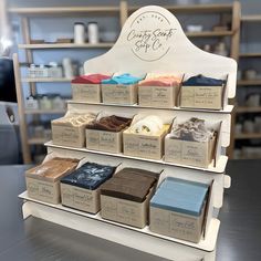 a display case filled with lots of different types of cakes and cupcakes in boxes