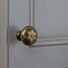 a close up of a door handle on a white door