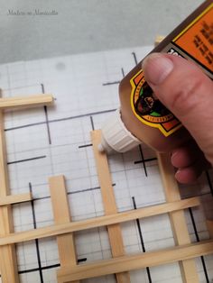 someone using glue to make a wooden frame