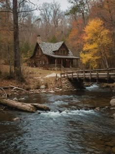 a log cabin sits on the edge of a stream in front of a wooden bridge