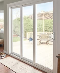 a living room with sliding glass doors that open up to a deck area and patio