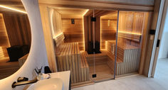 the inside of a sauna is lit up with lights and mirrors on the wall