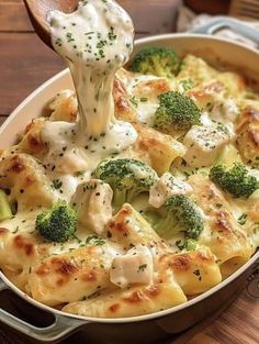 broccoli and chicken casserole being lifted with a wooden spoon