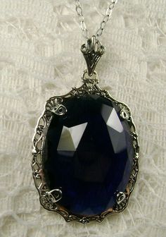 "Pendant Description Custom Inspired by Victorian era designs, I now offer this lovely Antique reproduction in sterling silver. The flawless simulated 22ct faceted blue sapphire is 24mm long (15/16th\") and 18mm in width (3/4th\"). The entire pendant is 1.5\" long and 7/8\" wide. The chain (if chosen) is between 16-18\" in length and is marked 925 as well. Notice the beautiful craftsmanship of the Victorian filigree setting. This pendant necklace is a true reproduction of and old Victorian cameo