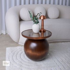 a living room with a white couch and wooden table on the rug in front of it