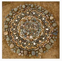 a circular design made out of rocks on the ground