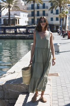 Style // A subtle, soothing and summer infused sage green linen maxi dress V-neck line and low back dress, The Sevilla Dress is a true goes-with-anything essential, guaranteed to turn heads in this timeless linen maxi dress with tie closures at the shoulders, and a tiered body for added dimension and versatility. With that perfect flowy and relaxed fit, the stunning Sevilla Dress was designed to be dressed up with a strappy sandal or barefoot for that effortlessly beautiful look! Fabric Note // Linen V-neck Sundress Maxi Dress, Chic Linen Maxi Dress For Day Out, Chic Green Linen Beach Dress, Linen Maxi Dress For Vacation, Linen Maxi Dress For Brunch, Chic Maxi Linen Dress For Brunch, Chic Linen Maxi Dress, Summer Sage V-neck Dress, Chic Linen Maxi Dress For Summer