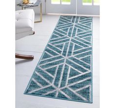 a blue area rug with white lines on the bottom and an off - white geometric design