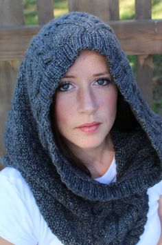 a woman wearing a gray knitted hood and scarf