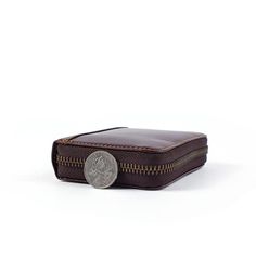 Looking for a chic & ultra-modern wallet? This compactly designed cow leather piece will be an extravagant addition to your collection. Easy going on the price & luxurious on the quality, this wallet has immaculate finesse with a high-end glossy shine to it. It comes in a plush cocoa coffee shade that is highlighted with dark brown threading on both its interior and exterior. It adorns a single zipper closure design with dull golden zippers that gives it a sleek appearance. The perfect size to fit into your pocket along with having enough room to fit eight cards to the maximum capacity and a small flap to keep that rattling change on the side. An attractive feature of cowhide leather is that the leather will improve in quality making it richer after more use. Top features include: Use of g Modern Leather Coin Purse For Business, Compact Leather Coin Purse For Business, Luxury Rfid Blocking Coin Purse For Business, Business Compact Card Holder With Coin Pocket, Compact Business Card Holder With Coin Pocket, Classic Rectangular Wallets With Zipper Pocket, Modern Leather Card Holder With Zipper, Modern Leather Card Holder With Zipper Closure, Classic Business Wallets With Zipper Pocket