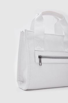 Introducing the "Canvas Fabric White Crossbody Bag" from Lunarity Garage – a chic and versatile accessory that combines the durability of canvas fabric with the timeless elegance of white. Crafted with meticulous attention to detail, this bag offers both fashion and functionality to suit your everyday needs. Elevate your style with the Canvas Fabric White Crossbody Bag – a perfect blend of durability and sophistication. The pristine white color adds a touch of refinement, making it a versatile a White Pouch Bag With Zipper Pocket, White Crossbody Canvas Bag With Zipper Closure, Trendy White Canvas Bag, Functional White Crossbody Bag, White Pouch Bag With Zipper Closure, White Large Capacity Crossbody Canvas Bag, White Satchel Shoulder Bag With Zipper Closure, White Crossbody Canvas Shopping Bag, White Pouch Shoulder Bag With Zipper Closure