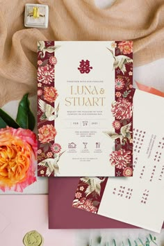 the wedding stationery is laid out with flowers