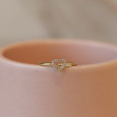 Our Hallow Heart Ring is crafted with a stunning hollow heart design. This adjustable ring is adorned with sparkling cubic zirconia stones on a sleek gold band. Elevate any look with this simplistic and versatile piece. *This ring is adjustable *18k gold plated Heart Rings, Indian Bridal Jewelry Sets, Gold Promise Rings, Hollow Heart, Heart Shaped Rings, Bridal Jewellery Indian, Bead Store, Bridal Jewelry Sets, Ring Finger