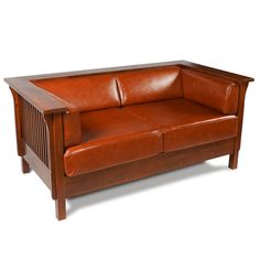 a brown leather couch sitting on top of a wooden frame