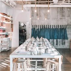 a long table is set up in the middle of a room with chairs and tables