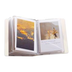 an open book with pictures on it and the pages opened to show a sunset scene