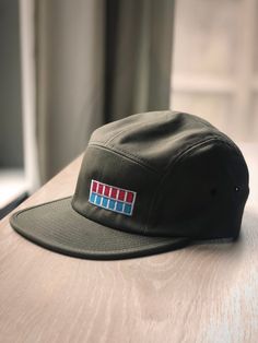 This embroidered camper-style cap is perfect for the Imperial officer on leave or the rebel just trying to blend in.Everything in the Gallery 94 shop is original artwork by me, Andy Wynn. You can find more of my work on Instagram @Gallery94art. Art for Geeks, Geeks for Art.FIVE-PANEL CAMPER HATThis camper-style cap has a low profile and nylon strap clip closure. Comfortable and classic! 100% cotton Soft-structured Five panel Low profile Metal eyelets Nylon strap clip closure Star Wars Imperial Officer, Camper Hat, Imperial Officer, Five Panel Hat, On Leave, Star Wars Imperial, Panel Hat, Star Wars Gifts, Low Profile