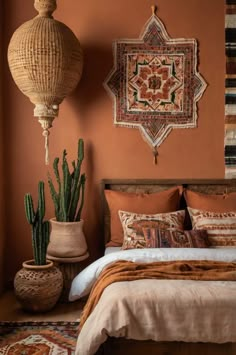 a bed room with a neatly made bed and two large cactuses on the wall