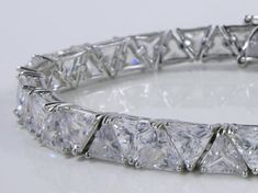 Gorgeous Handmade Bracelet, trillion diamond style cz stones, 18K White Gold plated on Silver. Perfect gift for you or your significant other, great for all kinds of occasions and celebrations! Elegant jewelry box included. Party Diamond Cut Tennis Bracelet, Dazzling Diamond Cut Tennis Bracelet For Party, Dazzling Diamond-cut Tennis Bracelet For Party, Diamond White Tennis Bracelet With Diamond Cut For Party, Party Tennis Bracelet In Diamond White With Diamond Cut, Diamond White Cubic Zirconia Bracelet For Anniversary, Dazzling Cubic Zirconia Tennis Bracelet As Gift, Party Diamond White Tennis Bracelet With Diamond Cut, Brilliant Cut Cubic Zirconia Diamond Bracelet For Party