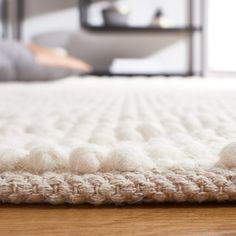 a close up view of a bed with white wool on the top and bottom edge