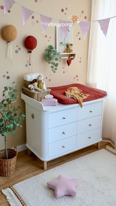 a baby's room is decorated in pink and gold