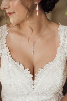 a woman wearing a wedding dress and necklace