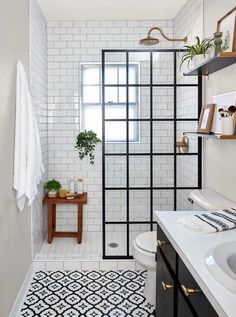 a white bathroom with black and white tile