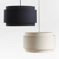 two black and white lamps hanging from the ceiling