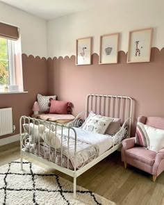 a bedroom with pink walls and white furniture