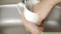 a person washing their hands in a sink