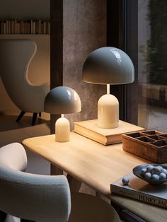 two lamps sitting on top of a wooden table