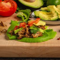 avocado, tomatoes and other vegetables on a cutting board