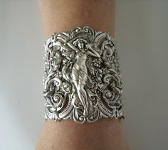 "This beautiful silver plated cuff bracelet has a silver plated art nouveau maiden, silver plated chain and lobster clasp. 2.75\" at the widest part. 7\" long adjustable to 9\" long." Victorian Cuff Bracelet For Wedding, Victorian Hallmarked Cuff Bracelet As A Gift, Art Nouveau Jewelry With Historical Design For Gift, Antique Wedding Cuff Bracelet With Intricate Design, Art Nouveau Jewelry With Historical Design As Gift, Silver Jewelry With Historical Design As Gift, Silver Jewelry With Historical Design For Gift, Handmade Victorian Cuff Bracelet For Wedding, Handmade Victorian Bracelets For Wedding