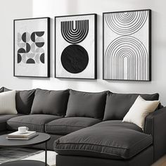 a living room with three black and white pictures hanging on the wall next to a couch