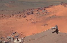 an aerial view of the surface of mars, with a camera attached to it's roof