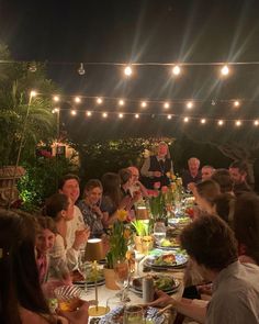 a group of people sitting around a dinner table