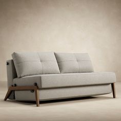 a white couch sitting on top of a wooden frame