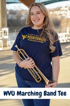 The WVU Mountaineer Marching Band Tee is a spirited garment that not only showcases your Mountaineer pride but also contributes to the success of the renowned West Virginia University Marching Band - The Pride of West Virginia! This exclusive shirt is not just a piece of clothing; it's a symbol of support for the talented musicians who bring energy and excitement to every game day. With every purchase of our tee we directly contribute 40% of the sale to fund the WVU Mountaineer Marching Band. Tank Top Shorts