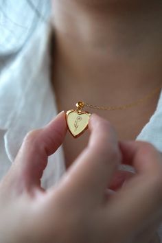 18-karat gold plated heart locket hangs on a sturdy 18-karat gold plated stainless steel chain.  Choose your chain length from the drop-down menu.   This locket is perfect for using as a keepsake necklace and is a thoughtful gift for someone special in your life. You can choose the locket as is, without photos, or have it personalized with your photo (s) and engraved your birth flower. You choose your options at checkout.  A mock-up of the photo will be done for your approval. Once approved, I w Heart Charm Pendant Jewelry For Wedding, Heirloom Locket Necklace With Heart Charm, Valentine's Day Heirloom Locket Necklace With Heart Charm, Heirloom Heart Charm Locket Necklace, Heirloom Heart Necklace For Gift, Heirloom Heart Locket Jewelry, Valentine's Day Medallion Locket Jewelry, Heirloom Heart Shaped Locket Jewelry, Heirloom Heart-shaped Locket Jewelry