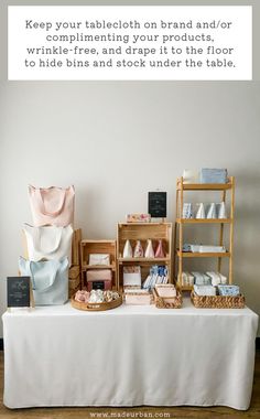 a table topped with lots of different items on top of a white cloth covered table