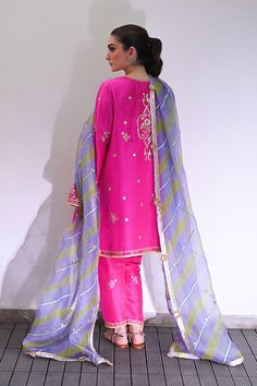 Channeling the old world charm of a kalidar kurta paired with shalwar, Serina is a striking hot pink number cut from pure rawsilk. The undulating trail of the geometric lime green and lavender contrasting organza dupatta hones in the ethereal aura. Model height: 5'3 Length: 38" Cut: relaxed fit In this price range, the Pink Silk Traditional Wear With Dabka Work, Pink Silk Kurta With Cutdana, Pink Silk Kurta With Cutdana Detail, Pink Cotton Silk Unstitched Suit With Sheer Dupatta, Designer Silk Pink Kurta, Designer Tissue Silk Pink Kurta, Pink Silk Sharara With Straight Kurta, Designer Pink Tissue Silk Kurta, Pink Unstitched Silk Sharara