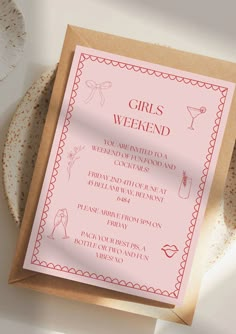 a pink and brown card with the words girls weekend written on it next to some plates