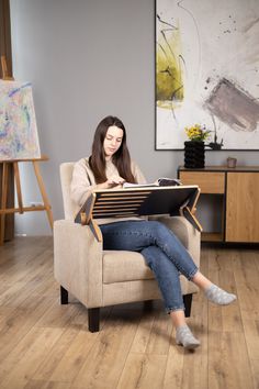 a woman sitting in a chair reading a book