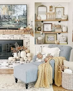 a living room filled with furniture and a fire place covered in fall decorating items