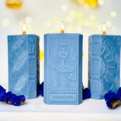 three blue candles sitting on top of a table