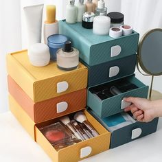 the drawers are organized with makeup and other beauty products on it's sides,